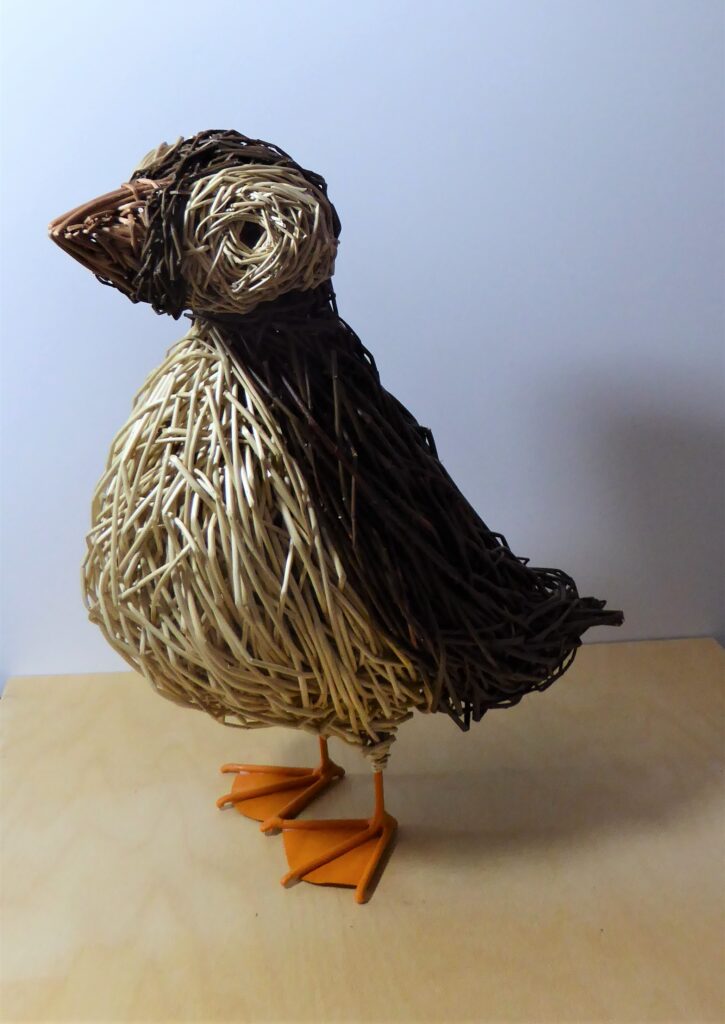 puffin willow sculpture, 2 shades of brown with creme belly and orange feet 